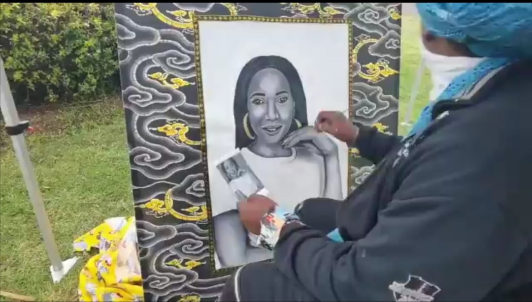 Rasta The Artist at the cemetery painting the late Mshoza live